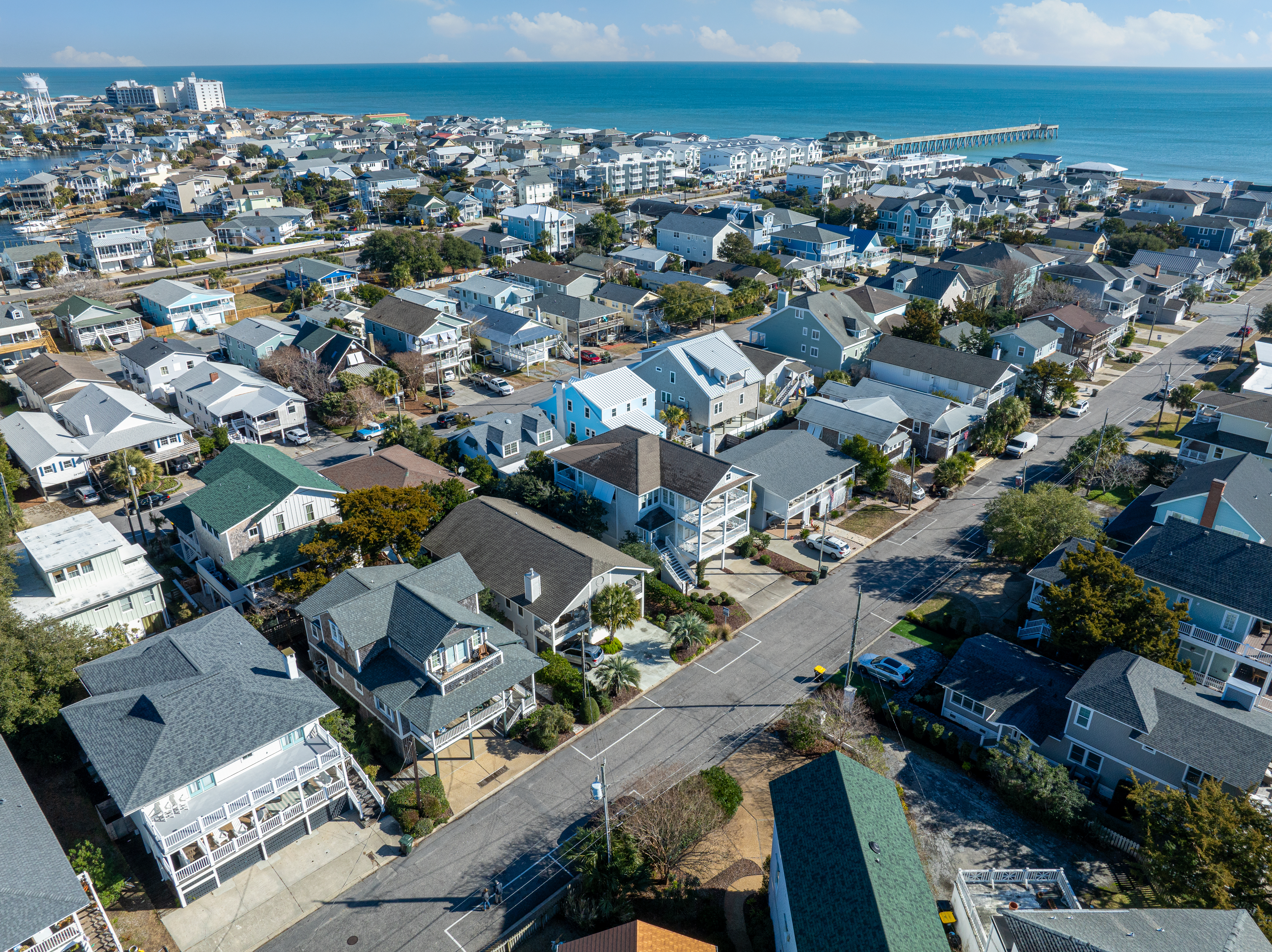 Wrightsville Beach from above, the ocean beyond the neighborhood rooftops